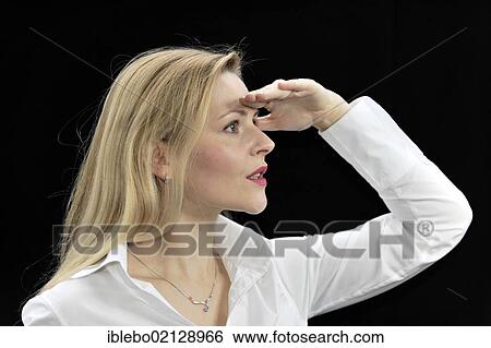 Young woman looking into the distance, searching, waiting View Large Photo Image Stock Photograph - Young woman looking into the distance, searching, waiting. Fotosearch