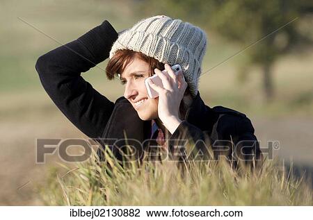 Young woman on the mobile phone, in natural environment View Large Photo Image Stock Image - Young woman on the mobile phone, in natural environment. Fotosearch