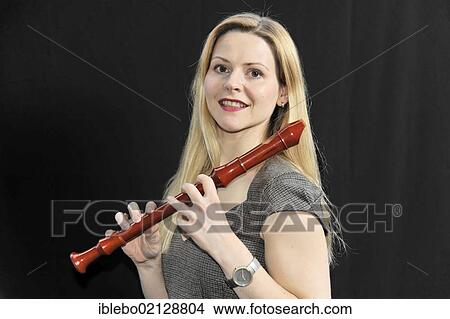 Young woman playing the alto recorder View Large Photo Image Picture - Young woman playing the alto recorder. Fotosearch