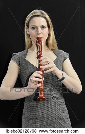 Stock Photo - Young woman playing the alto recorder. Fotosearch