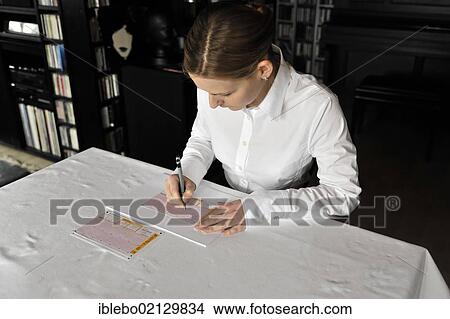 Young woman playing the lottery, filling out a lottery ticket View Large Photo Image Picture - Young woman playing the lottery, filling out a lottery ticket. Fotosearch