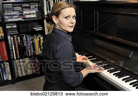 Young woman playing the piano View Large Photo Image Stock Image - Young woman playing the piano. Fotosearch