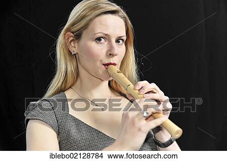 Young woman playing the recorder View Large Photo Image Picture - Young woman playing the recorder. Fotosearch