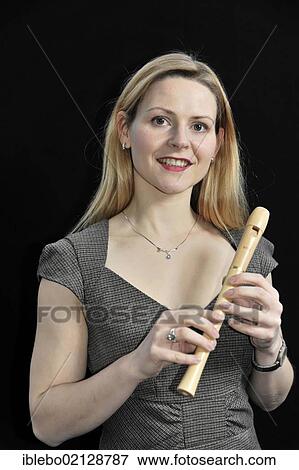 Young woman playing the recorder View Large Photo Image Stock Photo - Young woman playing the recorder. Fotosearch
