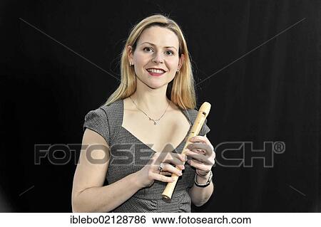 Young woman playing the recorder View Large Photo Image Stock Photograph - Young woman playing the recorder. Fotosearch