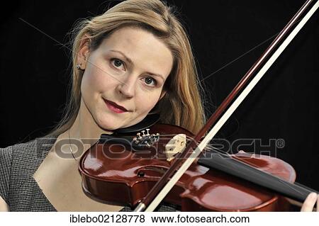 Stock Photo - Young woman playing the violin. Fotosearch
