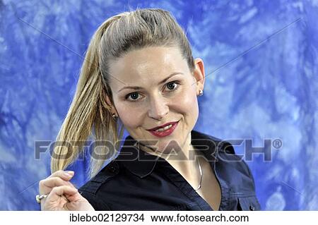 Picture - Young woman smiling, looking happy and content. Fotosearch