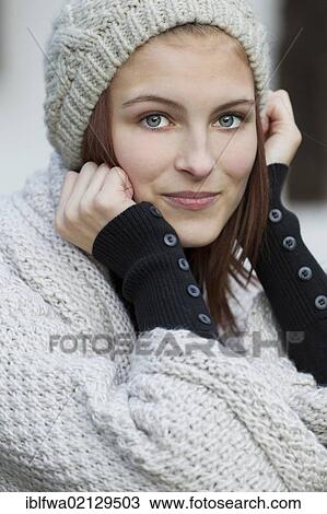Young woman wearing a cardigan and a woolen hat View Large Photo Image Stock Image - Young woman wearing a cardigan and a woolen hat. Fotosearch
