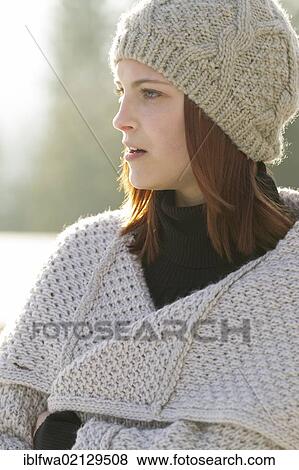 Young woman wearing a cardigan and a woolen hat View Large Photo Image Stock Photo - Young woman wearing a cardigan and a woolen hat. Fotosearch