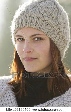 Young woman wearing a cardigan and a woolen hat View Large Photo Image Stock Photo - Young woman wearing a cardigan and a woolen hat. Fotosearch