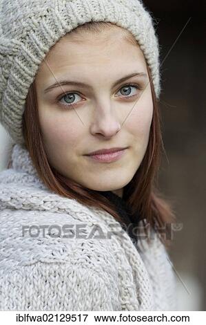 Young woman wearing a cardigan and a woolen hat View Large Photo Image Stock Photo - Young woman wearing a cardigan and a woolen hat. Fotosearch