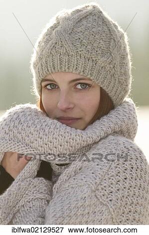Young woman wearing a cardigan and a woolen hat View Large Photo Image Stock Photo - Young woman wearing a cardigan and a woolen hat. Fotosearch