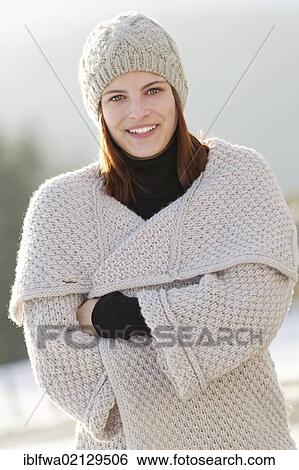 Young woman wearing a cardigan and a woolen hat View Large Photo Image Stock Photograph - Young woman wearing a cardigan and a woolen hat. Fotosearch