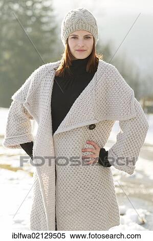 Young woman wearing a cardigan and a woolen hat View Large Photo Image Stock Photography - Young woman wearing a cardigan and a woolen hat. Fotosearch