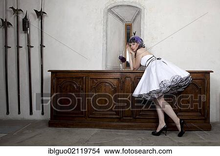 Picture - Young woman wearing a headdress and a white dress. Fotosearch