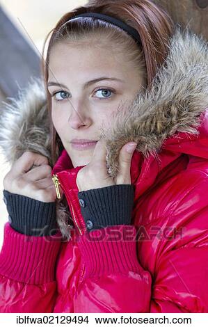 Picture - Young woman wearing a red anorak. Fotosearch