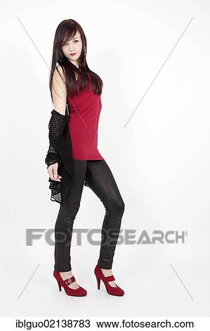 Young woman wearing a red top, latex leggings and red high heels View Large Photo Image Stock Image - Young woman wearing a red top, latex leggings and red high heels. Fotosearch