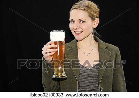 Stock Image - Young woman with a wheat beer. Fotosearch
