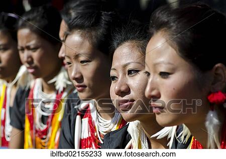 Stock Image - Young women of different tribes waiting to perform ritual dances at the Hornbill Festival, Kohima, Nagaland, India, Asia. Fotosearch