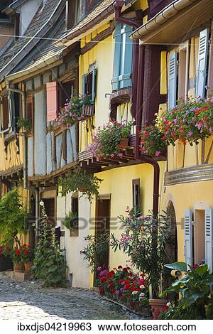Alley with colorful half-timbered houses decorated with flowers, Eguisheim, Alsace, France, Europe View Large Photo Image Stock Image - Alley with colorful half-timbered houses decorated with flowers, Eguisheim, Alsace, France, Europe. Fotosearch