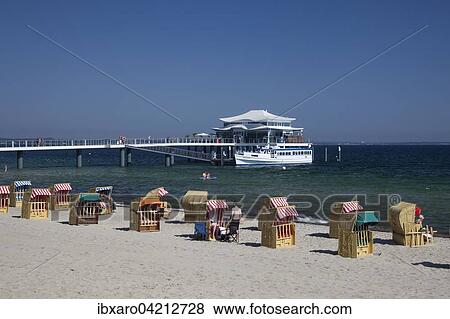 Beach chairs on Timmendorfer beach with Seeschlosschenbrucke bridge and Japanese teahouse, Bay of Lubeck, Baltic Sea, Schleswig-Holstein, Germany, Europe View Large Photo Image Stock Photo - Beach chairs on Timmendorfer beach with Seeschlosschenbrucke bridge and Japanese teahouse, Bay of Lubeck, Baltic Sea, Schleswig-Holstein, Germany, Europe. Fotosearch