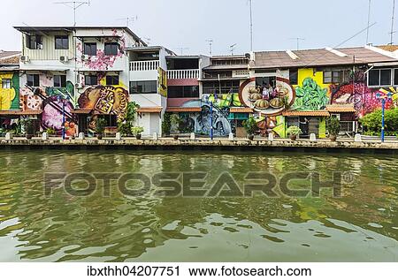 Stock Image - Brightly painted house fronts along the Malacca River, district of Kampung Bakar Batu, Malacca or Melaka, Malaysia, Asia. Fotosearch