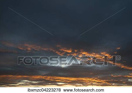 Clouds, illuminated orange during sundown, Alsace, France, Europe View Large Photo Image Stock Photo - Clouds, illuminated orange during sundown, Alsace, France, Europe. Fotosearch