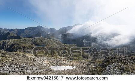Clouds passing over the ridge, Oberer Klaffersee, Klafferkessel, view from Greifenberg at 2618m, Schladming Tauern, Alps, Styria, Austria, Europe View Large Photo Image Stock Photo - Clouds passing over the ridge, Oberer Klaffersee, Klafferkessel, view from Greifenberg at 2618m, Schladming Tauern, Alps, Styria, Austria, Europe. Fotosearch