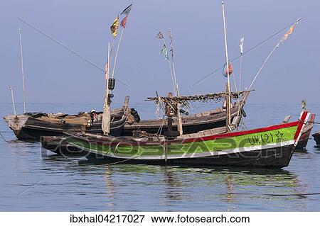 Colourful fishing boats in the sea off the beach of the fishing village of Ngapali, Thandwe, Rakhine State, Myanmar, Asia View Large Photo Image Stock Photo - Colourful fishing boats in the sea off the beach of the fishing village of Ngapali, Thandwe, Rakhine State, Myanmar, Asia. Fotosearch