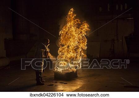 Picture - Firefighter extinguishes a heptane 2B-Pan fire with a 2-BTP extinguisher, Illinois, Chicago, USA, North America. Fotosearch