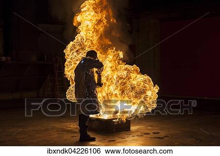 Firefighter extinguishes a heptane 2B-Pan fire with a 2-BTP extinguisher, Illinois, Chicago, USA, North America View Large Photo Image Stock Photograph - Firefighter extinguishes a heptane 2B-Pan fire with a 2-BTP extinguisher, Illinois, Chicago, USA, North America. Fotosearch