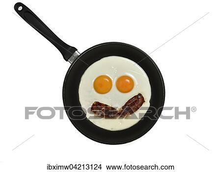 Fried eggs with bacon in pan, face with eyes View Large Photo Image Picture - Fried eggs with bacon in pan, face with eyes. Fotosearch
