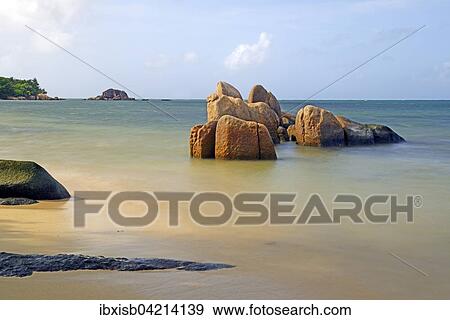 Stock Photo - Granite rocks in sea, Grand Anse beach, Praslin Island, Seychelles, Africa. Fotosearch