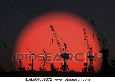 Harbor cranes against the rising sun, at sunrise, harbor, Hamburg, Germany, Europe View Large Photo Image Stock Image - Harbor cranes against the rising sun, at sunrise, harbor, Hamburg, Germany, Europe. Fotosearch