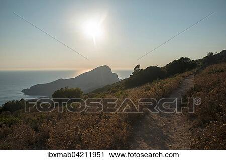 Stock Image - Hiking trail to Genoese tower, coastal and mountain scenery, Gulf of Porto, Corsica, France, Europe. Fotosearch