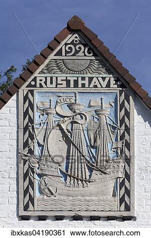Stock Image - Historical sailing ship, bas-relief of a villa from 1926, historic uptown de Concessie, seaside resort De Haan, West Flanders, Belgium, Europe. Fotosearch