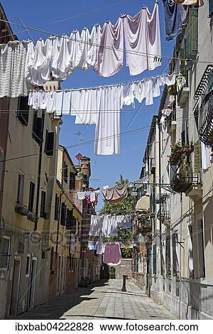 Laundry drying on clothes lines across the street, Castello district, Venice, Venezia, Veneto, Italy, Europe View Large Photo Image Stock Photo - Laundry drying on clothes lines across the street, Castello district, Venice, Venezia, Veneto, Italy, Europe. Fotosearch