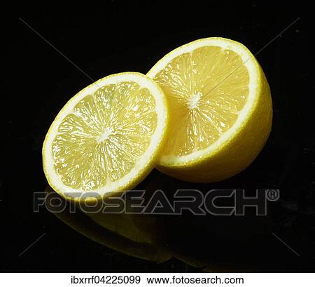 Lemon (Citrus limon), slice, sliced in half, against a black background View Large Photo Image Stock Photo - Lemon (Citrus limon), slice, sliced in half, against a black background. Fotosearch