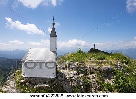 Stock Photography - Miniature chapel on the eastern summit, summit cross on the main summit, Hochgern mountain, Unterwossen, Chiemgau Alps, Upper Bavaria, Bavaria, Germany, Europe. Fotosearch
