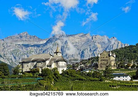Ringacker chapel and the town hall at the foot of the Bernese Alps, Leuk, Canton of Valais, Switzerland, Europe View Large Photo Image Stock Photo - Ringacker chapel and the town hall at the foot of the Bernese Alps, Leuk, Canton of Valais, Switzerland, Europe. Fotosearch