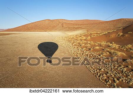 Shadow of a hot-air balloon in the Namib Desert, photographed from the basket of the balloon, Namib-Naukluft National Park, Namibia, Africa View Large Photo Image Stock Image - Shadow of a hot-air balloon in the Namib Desert, photographed from the basket of the balloon, Namib-Naukluft National Park, Namibia, Africa. Fotosearch