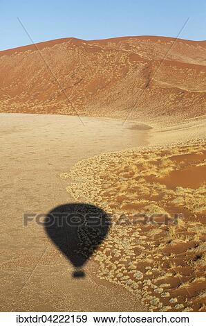 Shadow of a hot-air balloon in the Namib Desert, photographed from the basket of the balloon, Namib-Naukluft National Park, Namibia, Africa View Large Photo Image Stock Photo - Shadow of a hot-air balloon in the Namib Desert, photographed from the basket of the balloon, Namib-Naukluft National Park, Namibia, Africa. Fotosearch