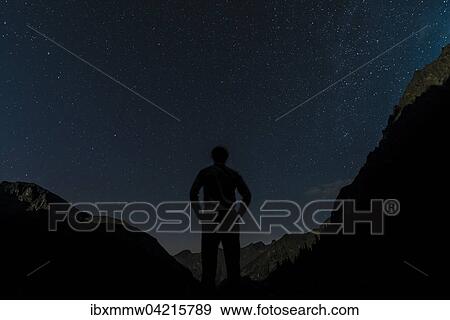 Stock Photo - Silhouette of person gazing at the stars, starry sky at night, Rohrmoos-Untertal, Schladming Tauern, Alps, Styria, Austria, Europe. Fotosearch