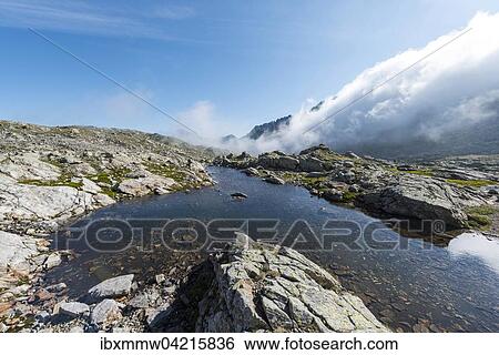 Stock Photograph - Small mountain lake in Klafferkessel, Greifenberg 2618m, Rohrmoos-Untertal, Schladming Tauern, Alps, Styria, Austria, Europe. Fotosearch