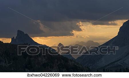Sunset at Valparola Pass, Hexenberg with summit cross, little Lagazuoi on the right, Dolomites, Alps, Veneto, Italy, Europe View Large Photo Image Stock Photo - Sunset at Valparola Pass, Hexenberg with summit cross, little Lagazuoi on the right, Dolomites, Alps, Veneto, Italy, Europe. Fotosearch