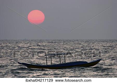 Stock Photo - Sunset over the sea, small fishing boat, Ngapali Beach, Thandwe, Rakhine State, Myanmar, Asia. Fotosearch