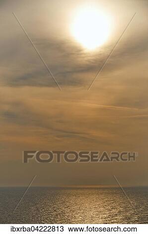 Stock Image - Water surface shimmering in the golden sunlight, Baltic Sea, island of Usedom, Mecklenburg-Western Pomerania, Germany, Europe. Fotosearch