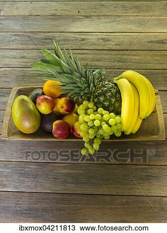 Wooden bowl full of fruit, bananas, pineapple, grapes, mango, nectarines View Large Photo Image Stock Image - Wooden bowl full of fruit, bananas, pineapple, grapes, mango, nectarines. Fotosearch