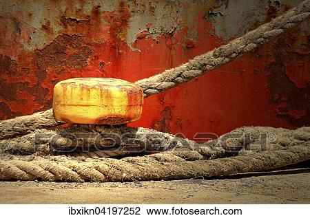 Yellow bollard with ropes wrapped around, in front of rusty a ship's hull, Crete, Greece, Europe View Large Photo Image Stock Image - Yellow bollard with ropes wrapped around, in front of rusty a ship's hull, Crete, Greece, Europe. Fotosearch
