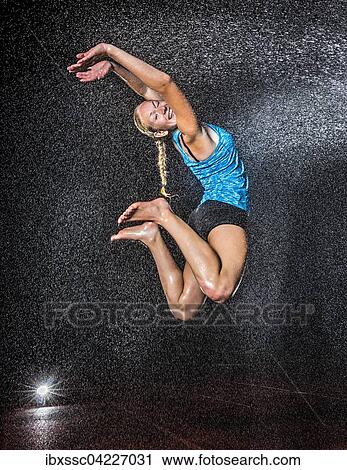 Young woman, 18 years old, jumping in mist, rain View Large Photo Image Stock Image - Young woman, 18 years old, jumping in mist, rain. Fotosearch